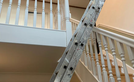 Painting staircase using ladders