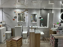 Bathroom showroom displaying multiple sink and toilet display units with mirrors
