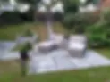 a large garden with furniture and landscaping