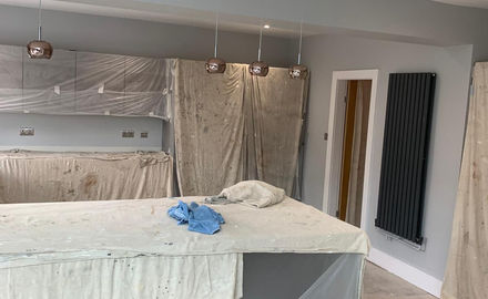 Kitchen covered with dust sheets being redecorated