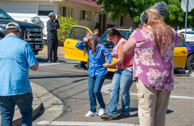 Close-up view of a film set with extras waiting in costume