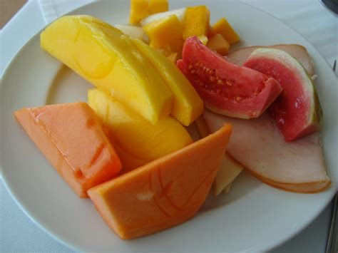 A plate of freshly cut fruit, watermelon, papaya, and mango and melon