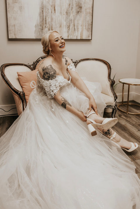 Bride putting shoes on  at the Burch on twenty seven wedding venue in Harris Couty Georgia near atlanta ga, wedding venue near columbus, ga , wedding venue near lagrange ga, wedding venue near phenix city alabama