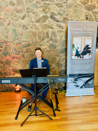 Pianist performing on mobile digital piano inside Boettcher Mansion stone-walled room