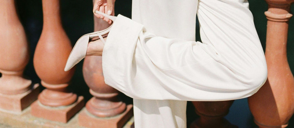 stylish woman wearing white suit and heels