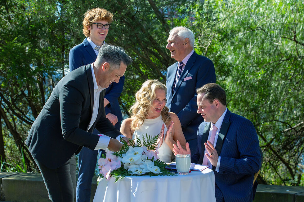 the moment when things suddenly go a little quiet. The adrenaline dips, the photographer adjusts their lens, and the couple sits down to sign the marriage documents.