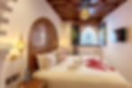 Elegant room with carved bed and ornate window