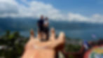 Bonnie and Ky Coffey in a giant hand overlooking Lake Atitlan.