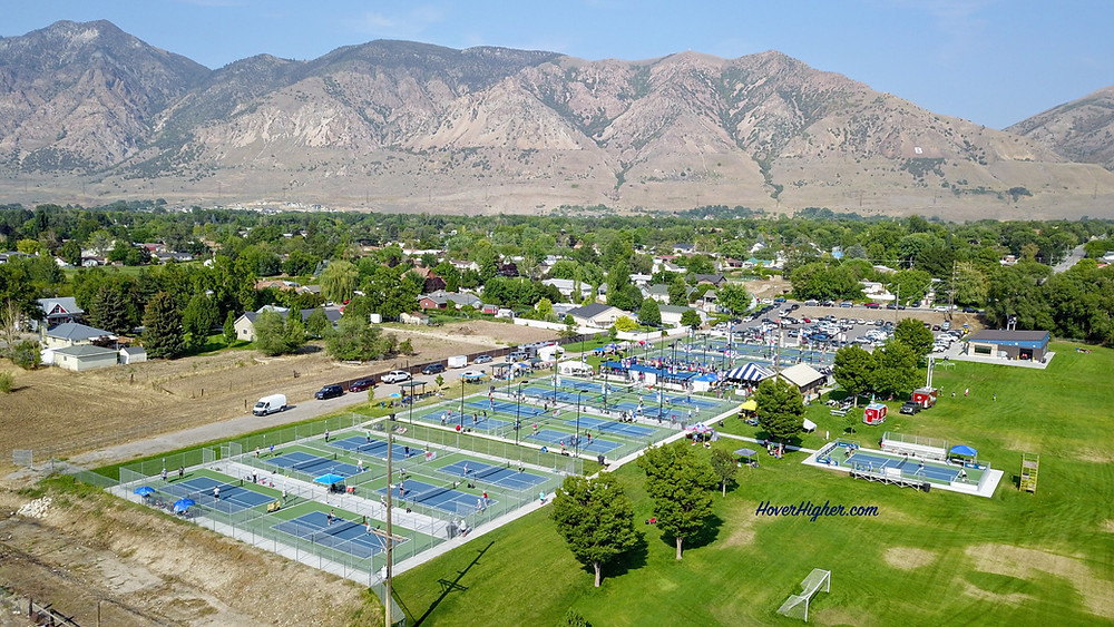 Rees Pioneer Park Tournament of Champions Pickleball Courts 2021 in Brigham City HoverHigher.com drone shot aerial view with mountains in background