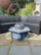 small blue hexagon pond with ceramic water feature and outdoor seating