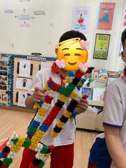 Tom posing with the robot he built