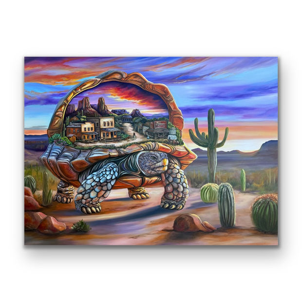 The framed Secrets of a Desert Dweller canvas by Dani Abbott angled against an open desert backdrop.