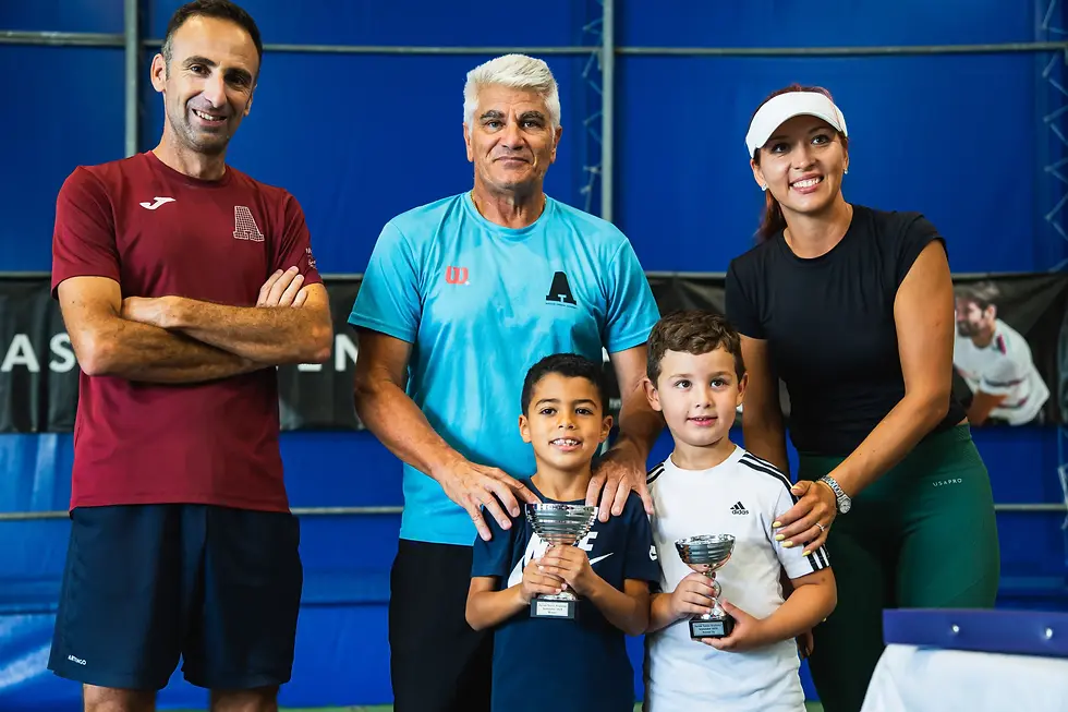 Asciak Tennis Academy Juniors holding a trophy