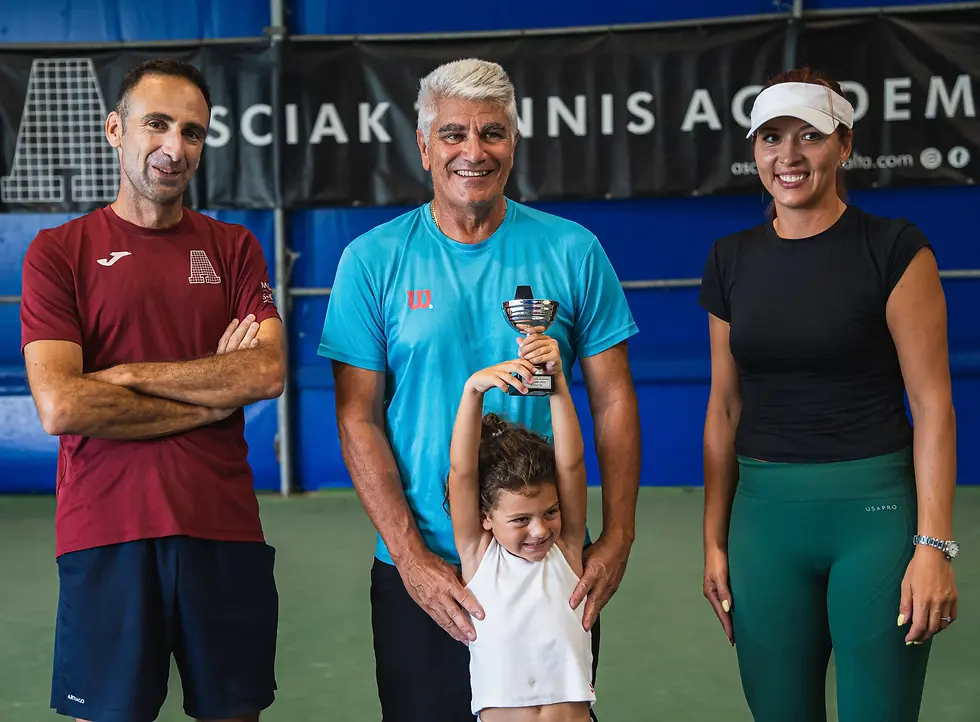 Asciak Tennis Academy Junior holding a trophy