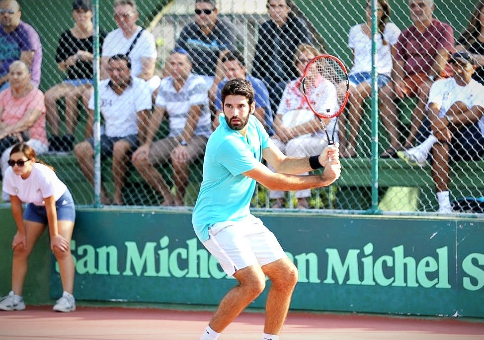 Matthew Asciak hitting a tennis backhand