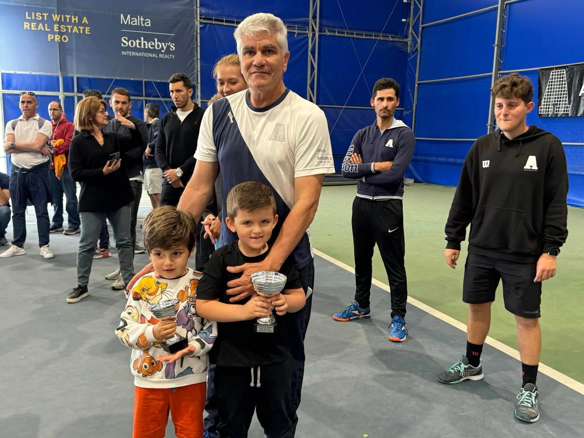 Tennis kids with trophy