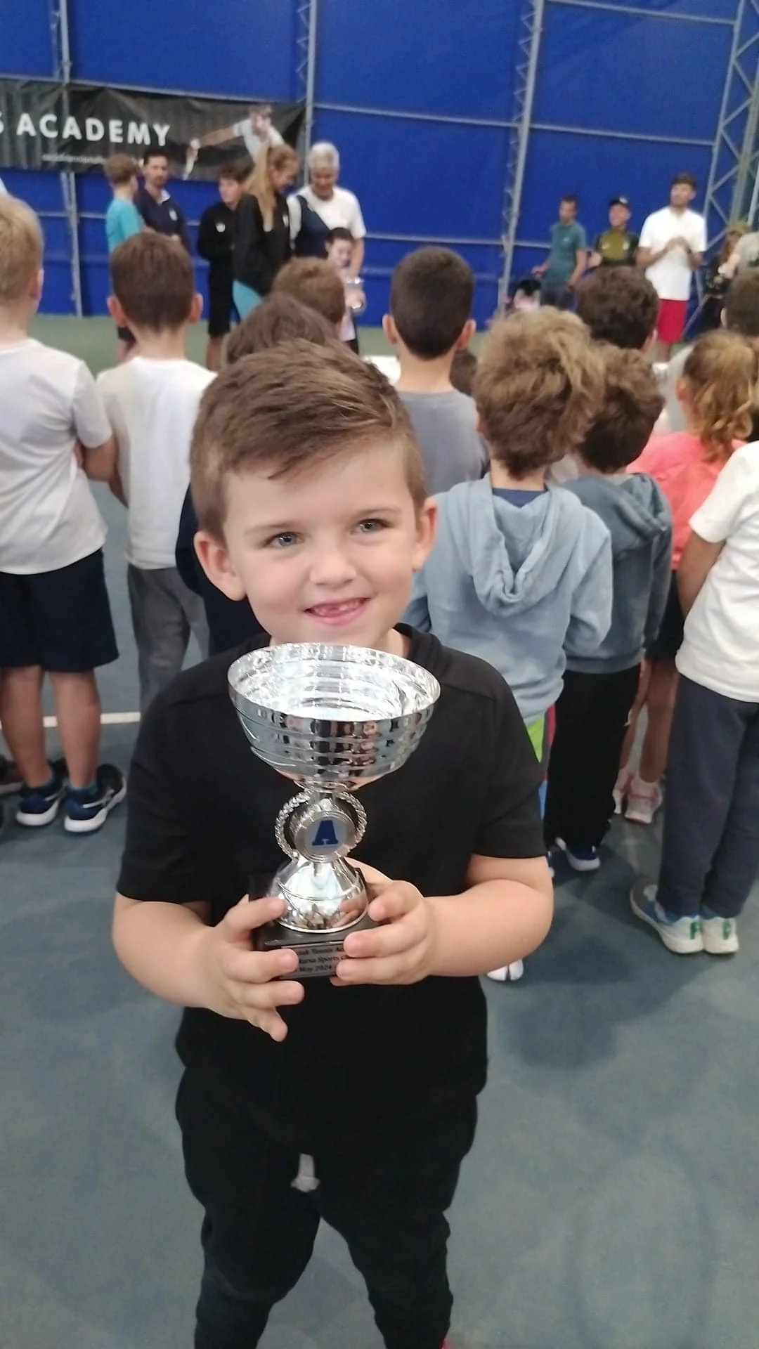 Tennis kids with trophy