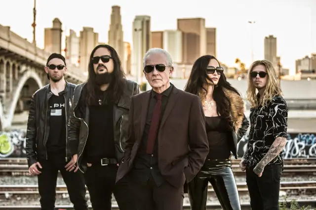 Graham Bonnet band posing with a city landscape in the background