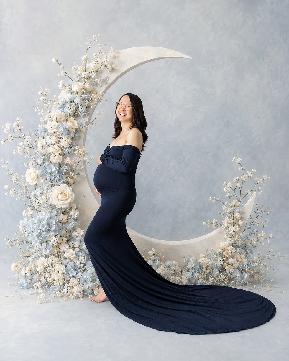 Pregnant mom laughing against blue studio backdrop, maternity photographer Long Island