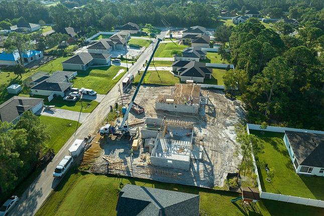 aerial-view-of-lifting-crane-and-builders-working-2024-12-07-01-54-06-utc.jpg