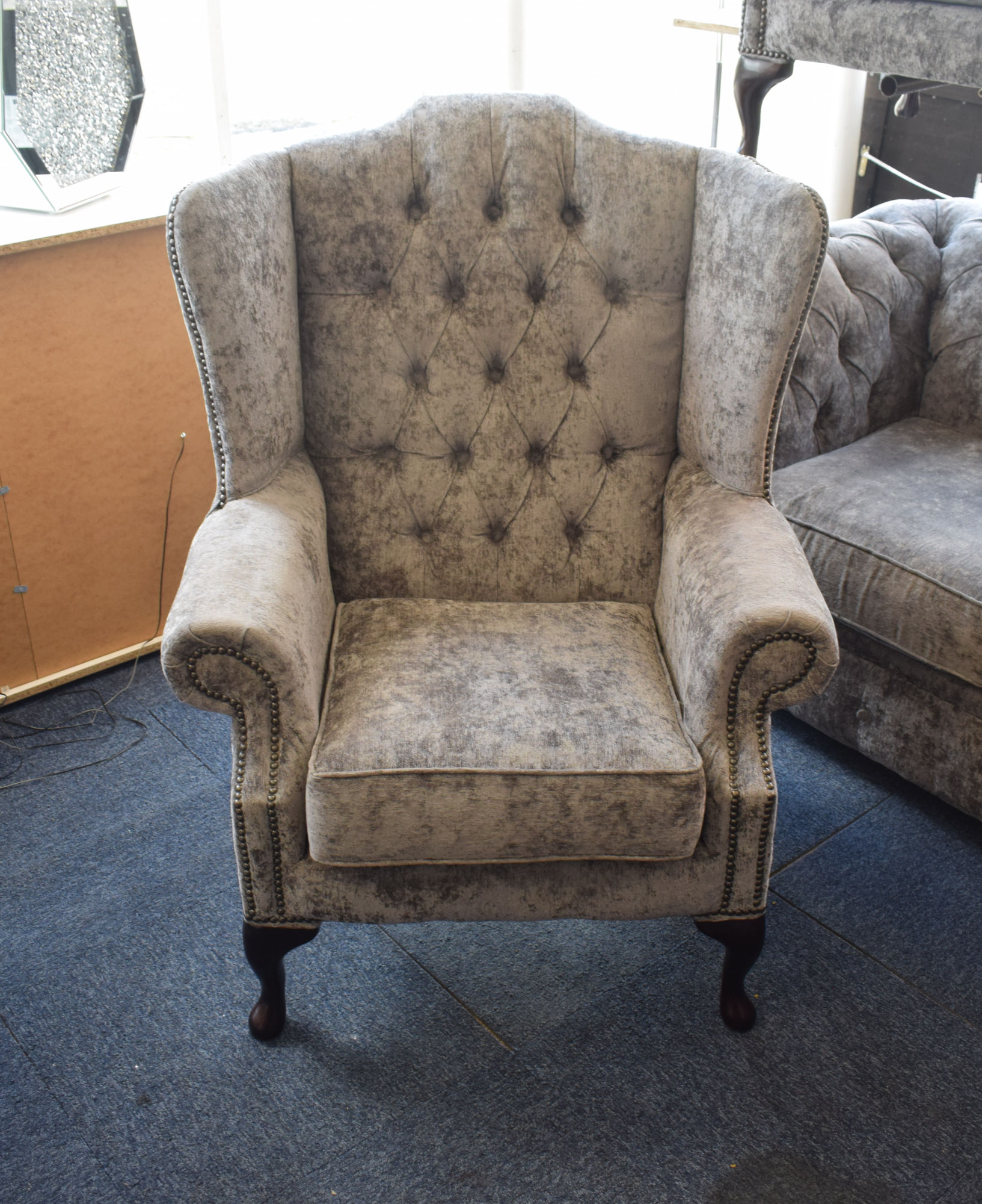 Grey fabric chesterfield armchairs