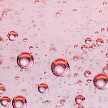 Dimethyl Isosorbide, sustainable Scibel ingredient, represented as liquid bubbles on pink bakcground
