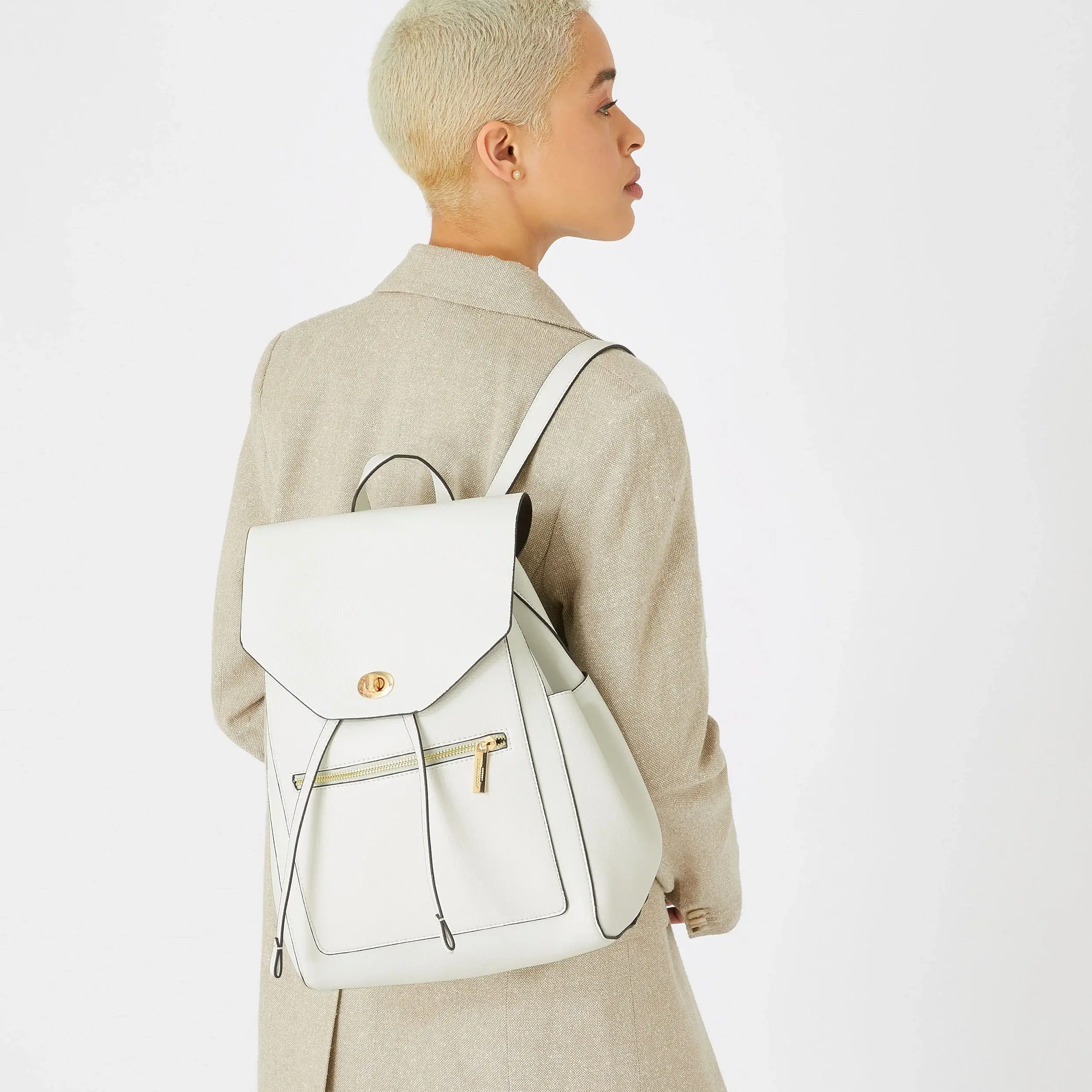 a woman carrying a white backpack