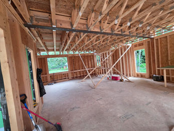 Interior wood wall framing and roof trusses inside a residential structure