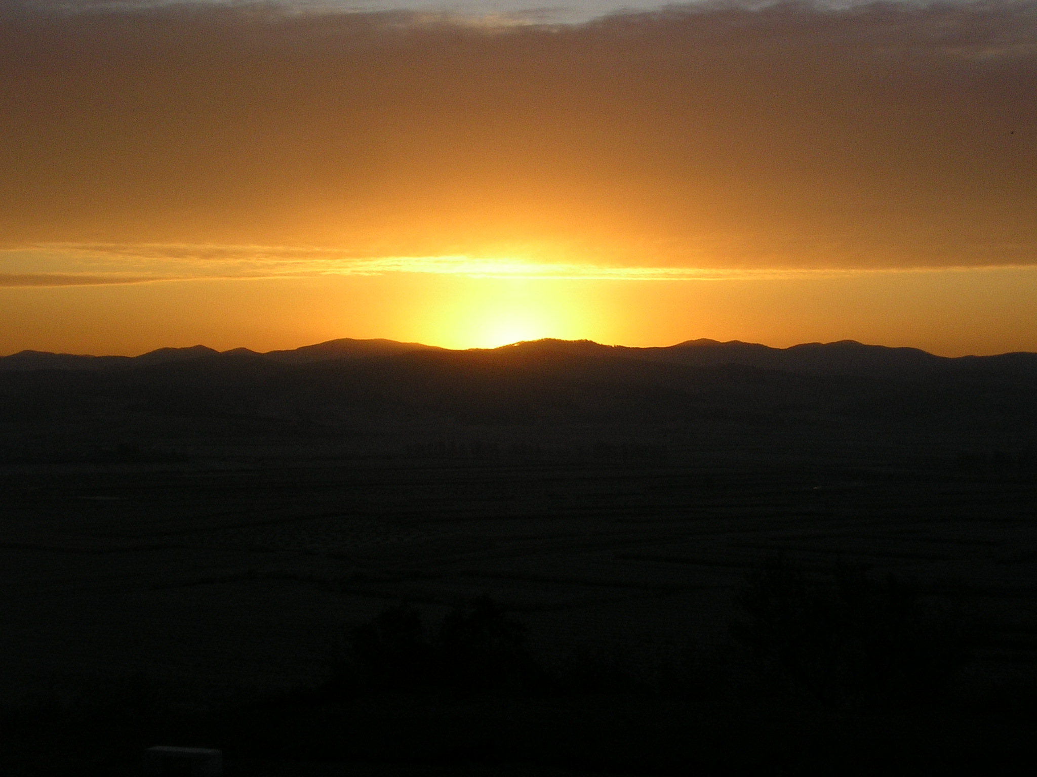 Sunset over hills near the school