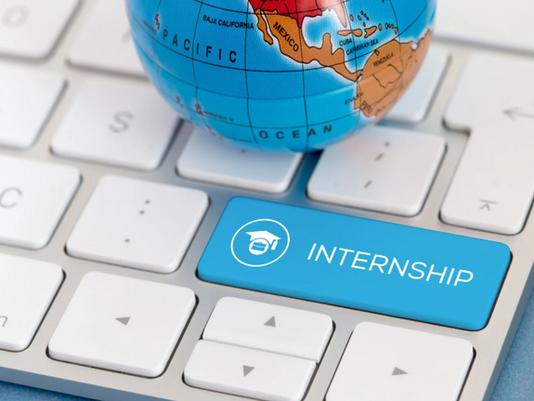 Keyboard key with the word "Internship" and a graduation cap icon next to a globe showing a world map.