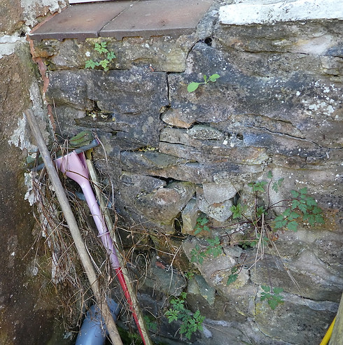 Natural stone wall with heavy cracking