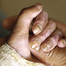 adult holding child's hand