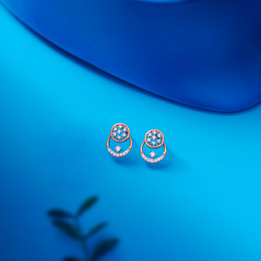 Elegant diamond earrings on blue background