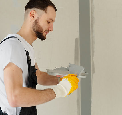 medium-shot-worker-using-plastering-trowel.jpg