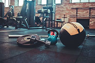 disassembled-barbell-medicine-ball-kettlebell-dumbbell-lying-floor-gym-sports-equipment-wo