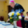 Bishop Frank cutting the cake