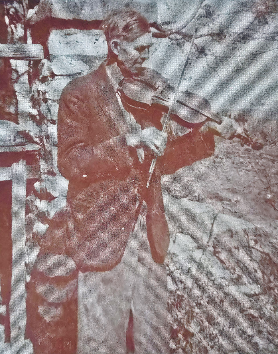 Charles Vining in the late 1940s fiddling a tune next to the front steps of Old Matt's Cabin. (Photo courtesy of John Fullerton)