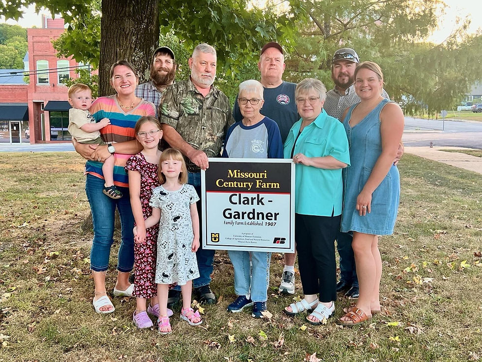 (Left to right): Blake, Aubrey, Harper, Hadassah and Hayes Simmons; Latishia Clark holding the sign; Jeff Clark behind Latishia; Tim and Debby Gardner; and Luke and Erica Gardner (Photo submitted by Stone County Extension)