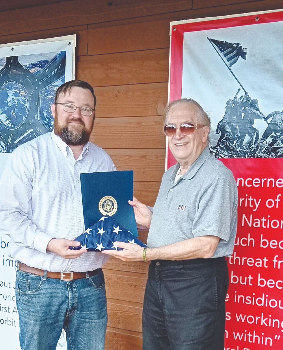 Branson West museum director and curator Jim Zbick, right, receives a flag that was flown over the U.S. Capitol from Jared Taylor, Field Representative for Congressman Eric Burlison’s district office. (Photo submitted by Jim Zbick)
