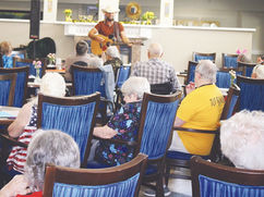 Isaac Kenneth entertains residents at The Gardens