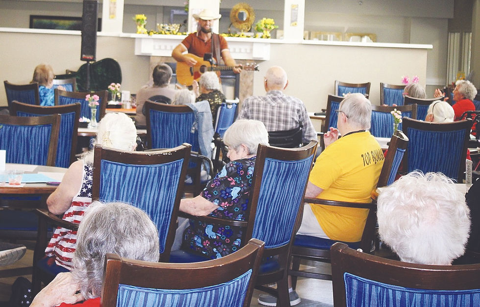Isaac Kenneth entertains residents at The Gardens