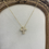 Thumbnail: Gold Rhinestone Bubble Cross Necklace