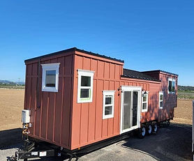 The Coral tiny house boasts an impressive exterior featuring dual pane windows, a metal roof, R13 insulation in