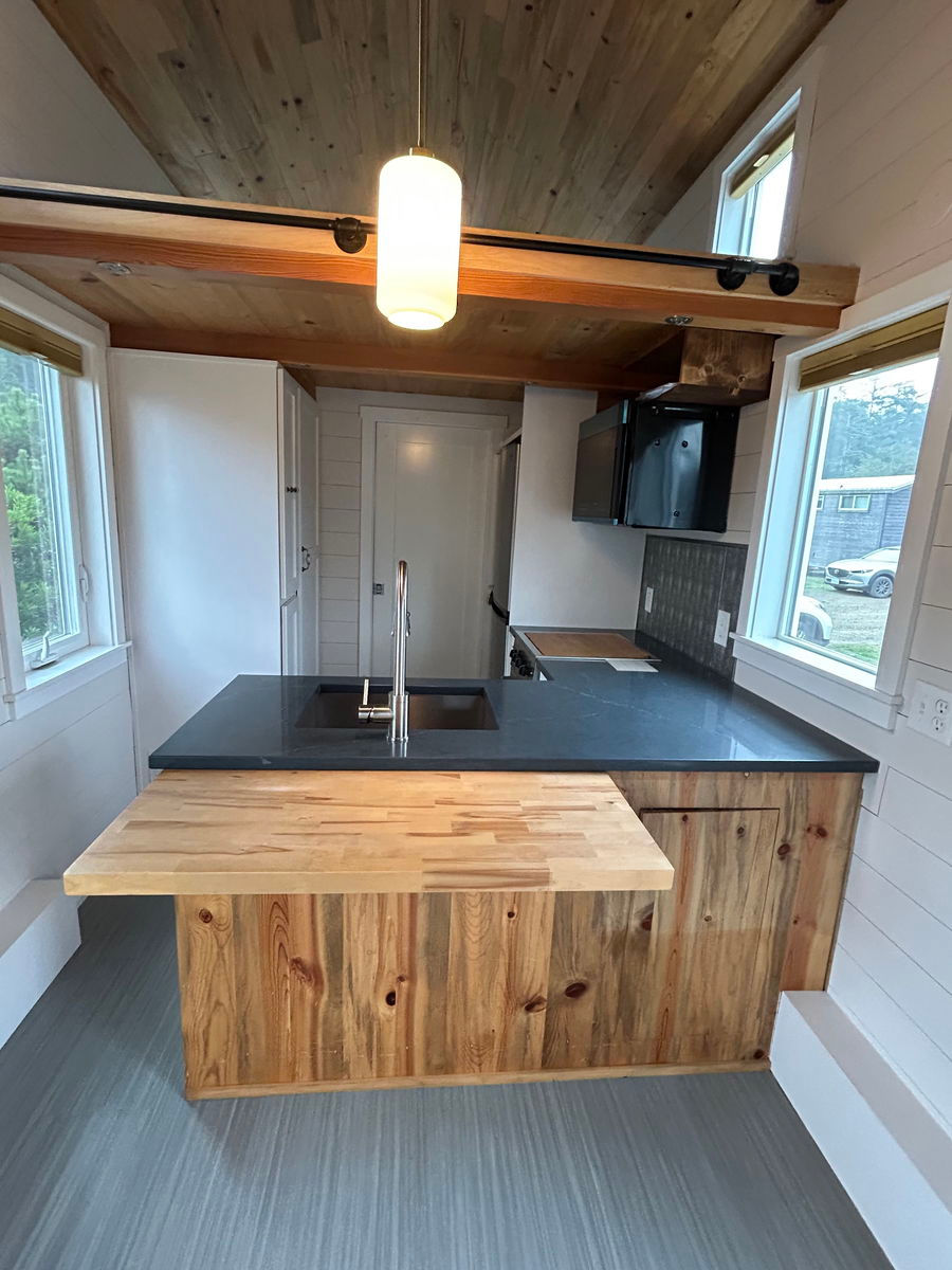 Thumbnail: Nestled on a sturdy gooseneck trailer, this mobile home offers ample space,