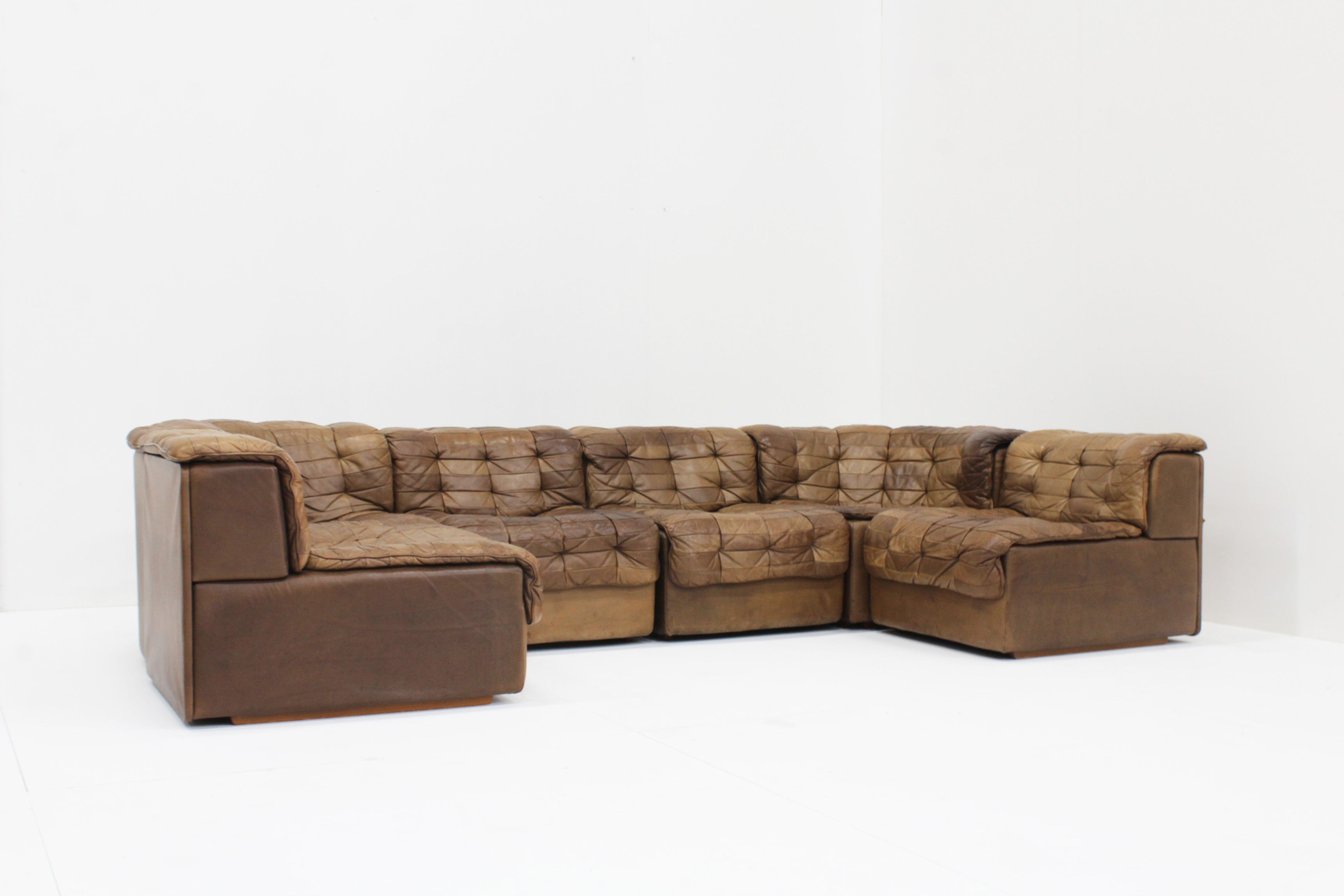Vintage De Sede DS 11 modular sofa in brown patchwork leather from Switzerland, 1970s. The sofa is very large and has multipl