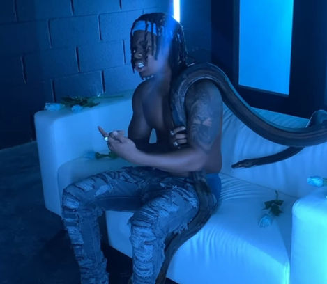 Poundz holding a snake