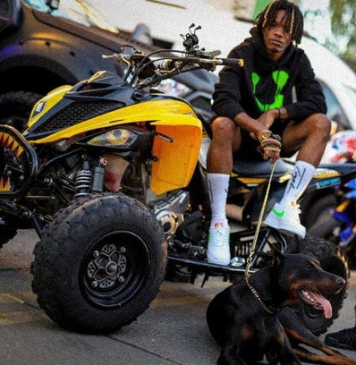 Young Teflon holding a dog