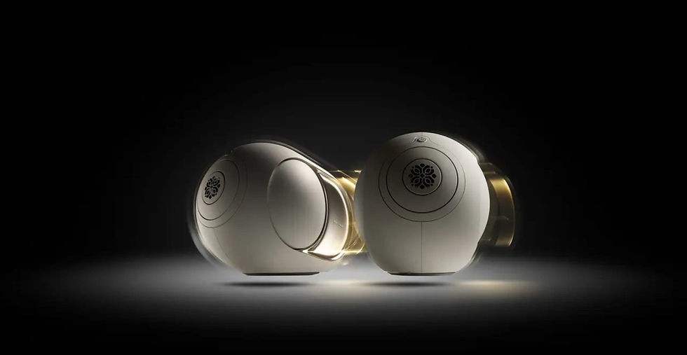Two futuristic white speakers with gold accents are lit dramatically against a dark background, creating a sleek and modern ambiance.