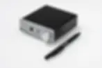 Black headphone amplifier "Head Box E" with silver front, knobs, and jacks, next to a black pen on a white surface.