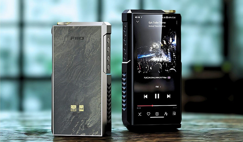 Two digital audio players on a table; one displays a concert screen. Sleek design with silver and black tones. Bright, blurred background.